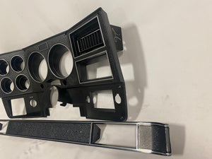 1984-1987 Good Used dash bezel, black with silver trim; New AC vent, and passenger side plate